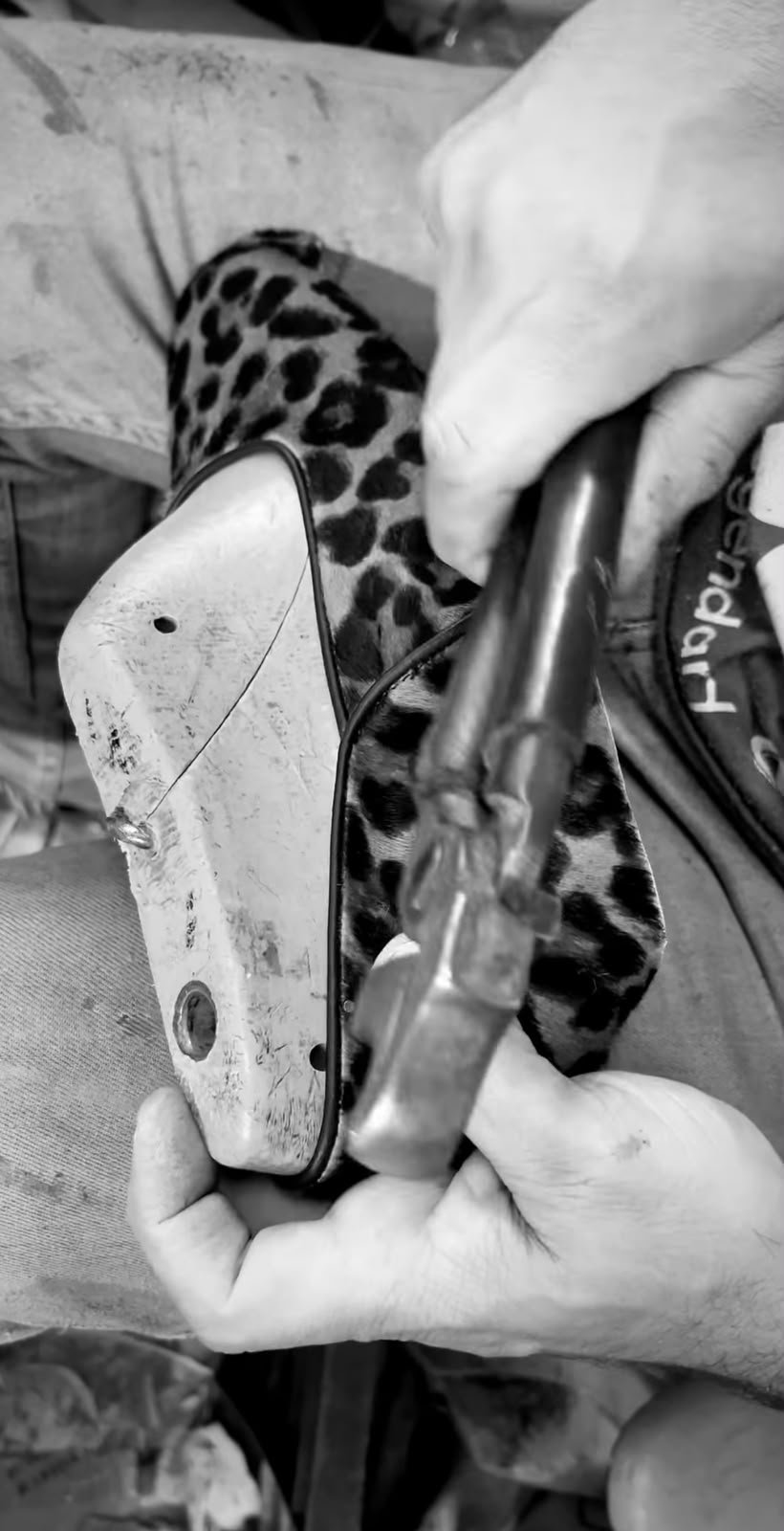 Artisan shaping a leopard loafer by hand in the Casablanca workshop